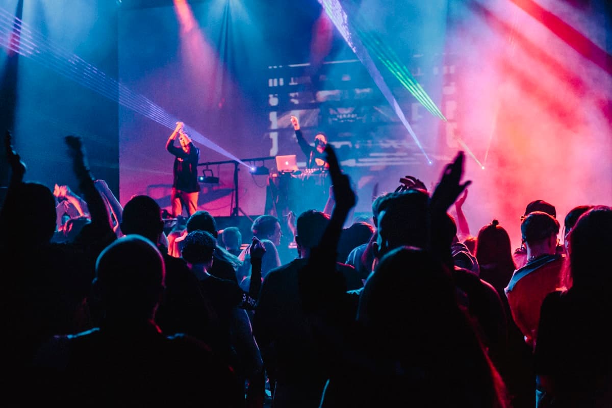 A four-piece band mid-song under warm stage lights