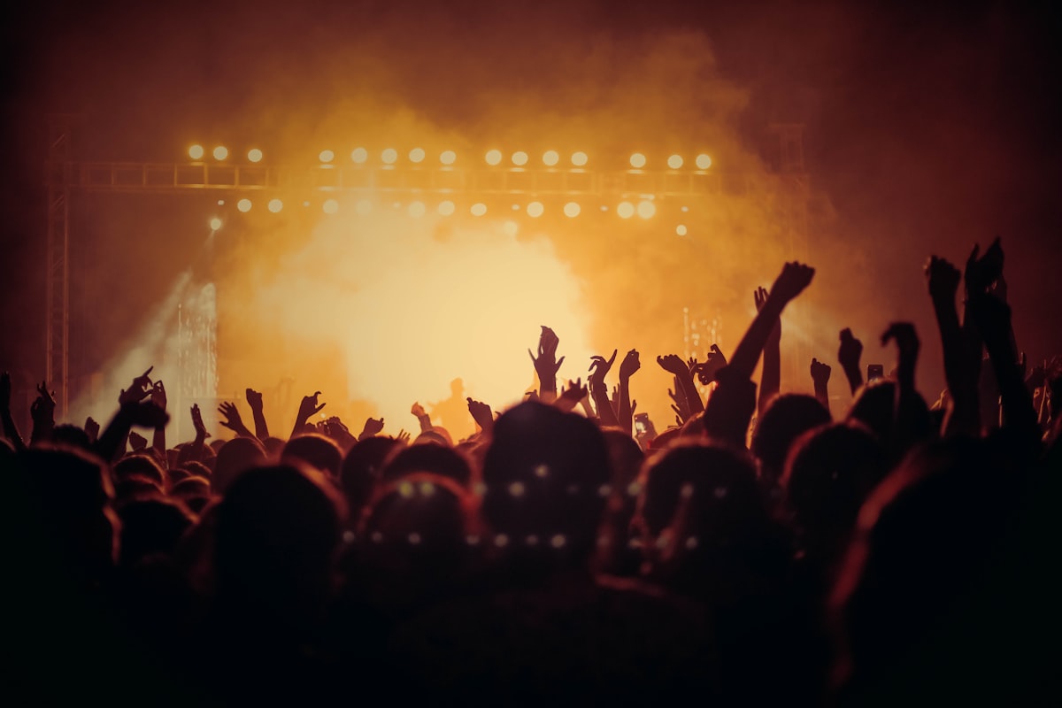 A performer at the microphone under one warm spotlight