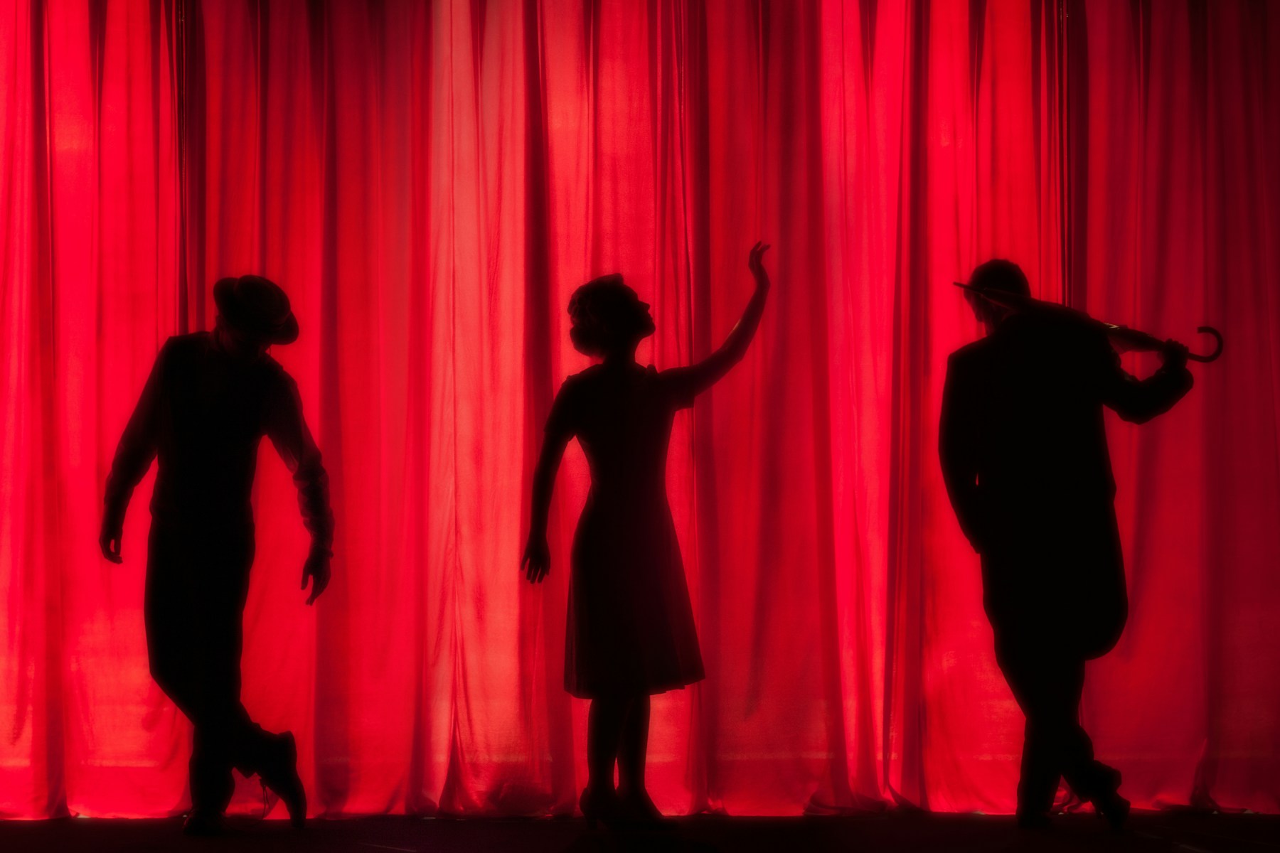 Performance image for Banjara Hills Live — theatre performers silhouetted against a red curtain